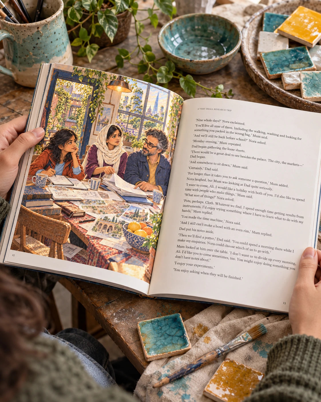 Illustrative photograph: An open illustrated book among handmade ceramic glaze test tiles on a ceramics studio workbench, turquoise, honey and chalk glazes, a brush laid on linen.